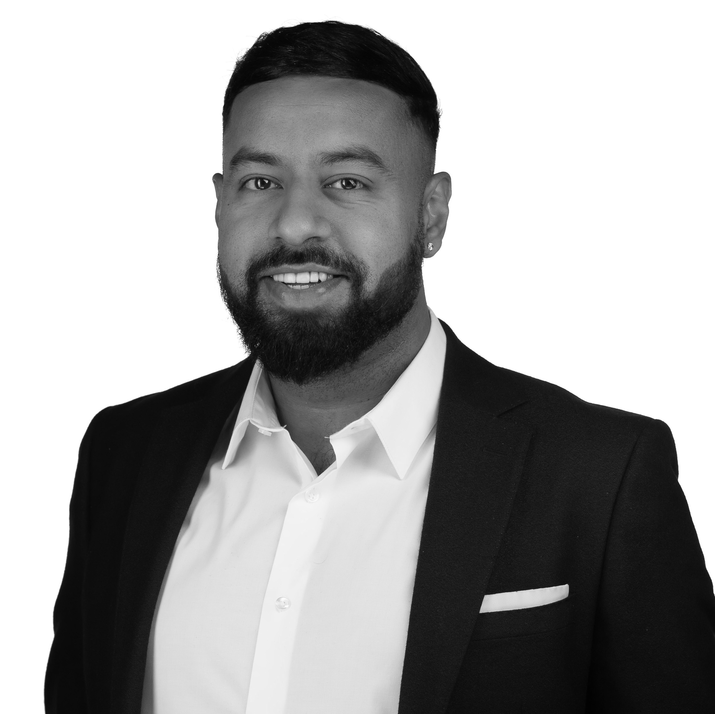 A black and white headshot image of a smiling man against a white backdrop
