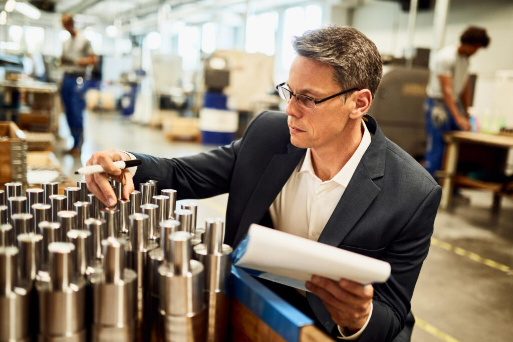 Male business owner checking industrial supplies