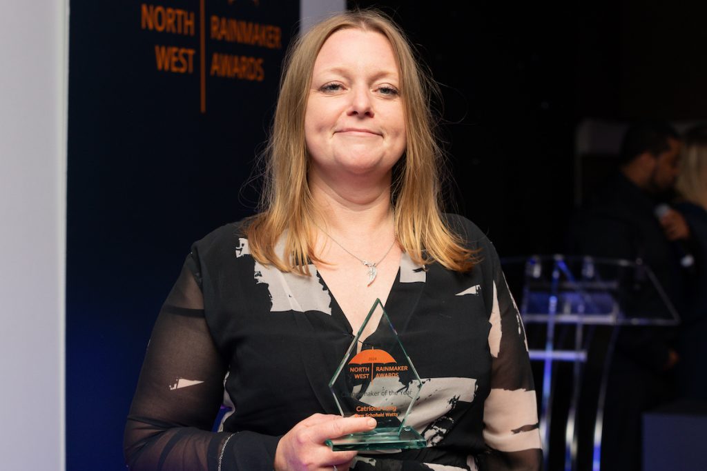 Catriona Lang proudly holding the Changemaker of the Year award at the North West Rainmaker Awards 2024.