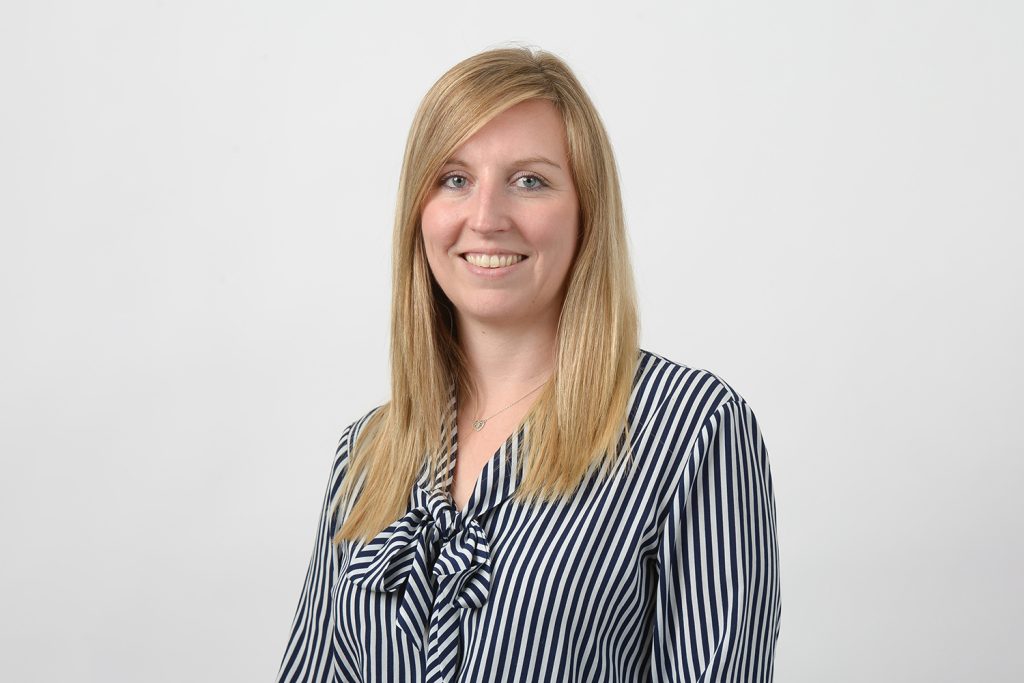 A professional headshot of a woman with a friendly smile.