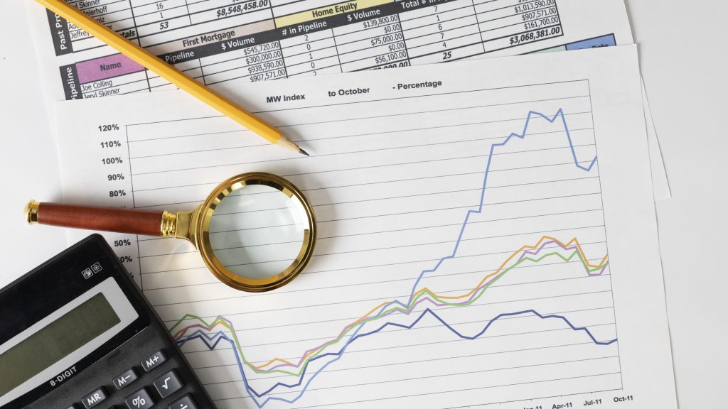A close-up view of financial graphs showing peaks and troughs.