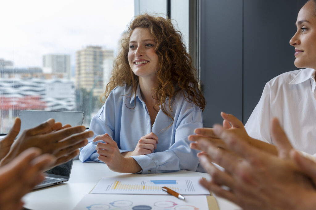 A young professional woman expresses appreciation for her workmates